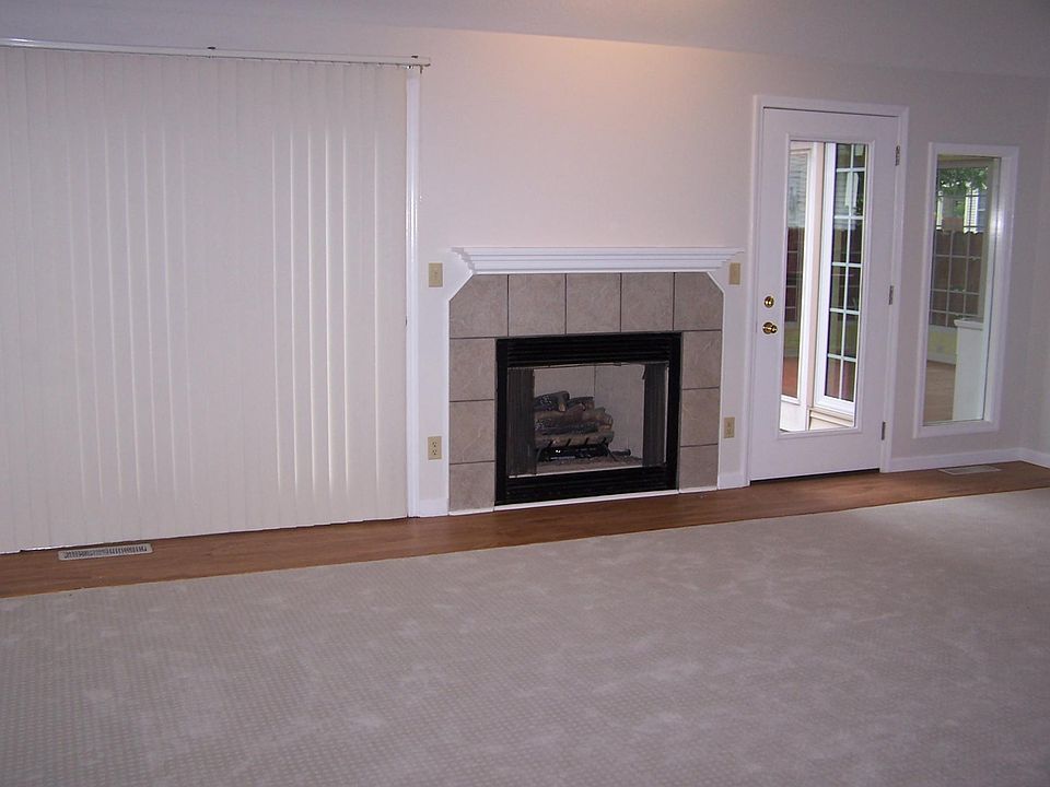 Great room with gas fireplace accessing wood deck.