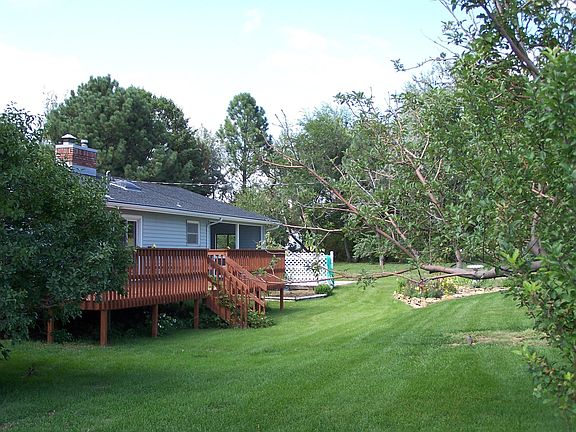 Huge deck overlooking landscaped backyard
