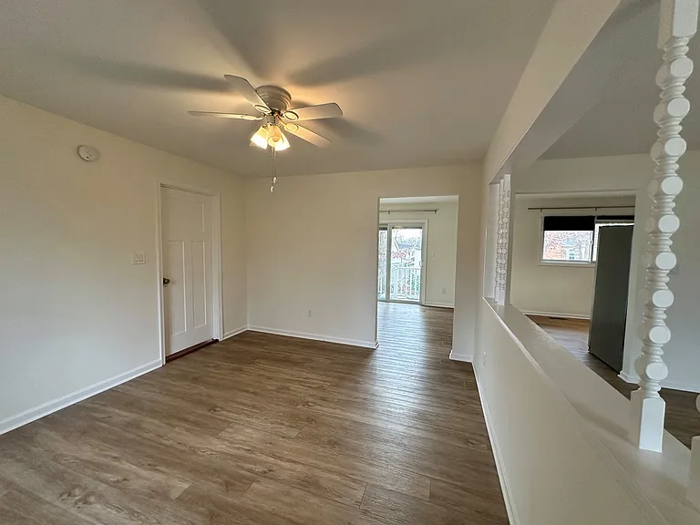 Another view of the bonus room, kitchen, dining room, and living room,