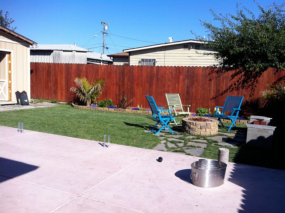Large backyard with shed and fire pit