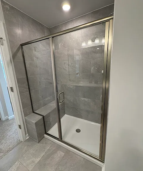 Large shower with floor to ceiling tiles