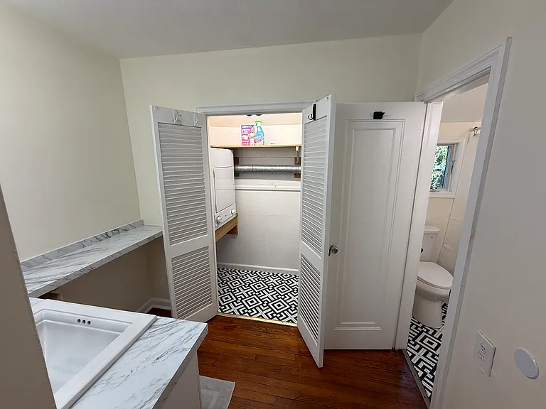 Dressing area, private bathroom with tub/shower combo, and washer and dryer.
