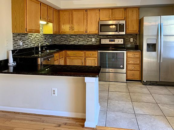 Remodeled kitchen with stainless appliances and granite countertops.