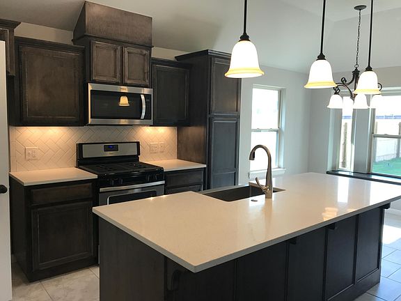 Herringbone subway tile backsplash and gas stove!