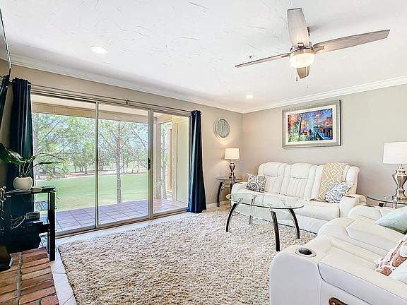 Comfy living room with white-leather power recliners.
