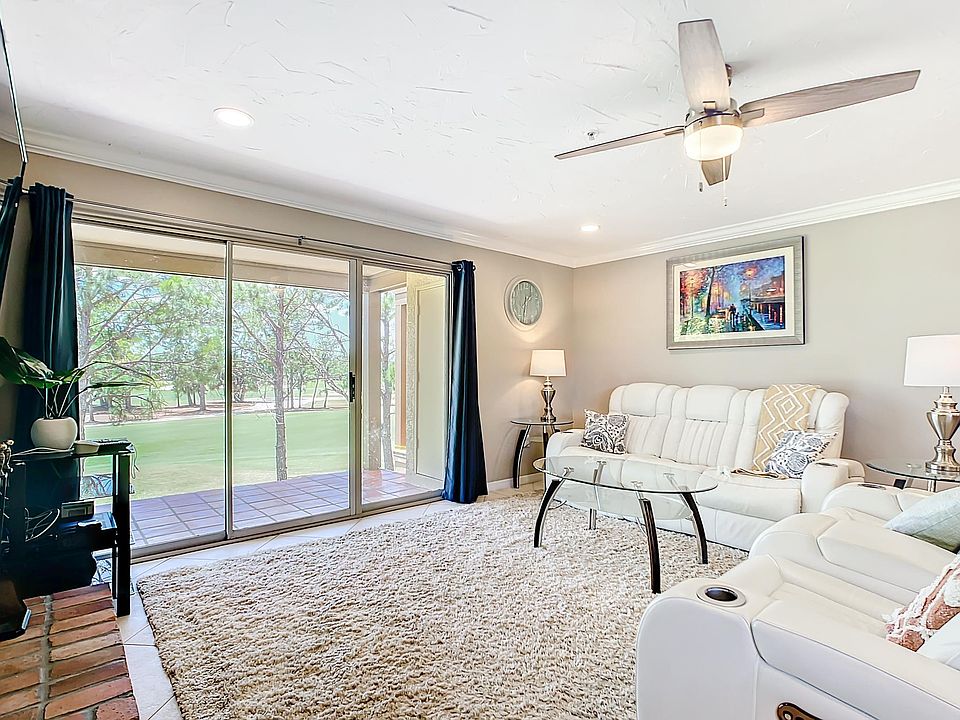 Comfy living room with white-leather power recliners.