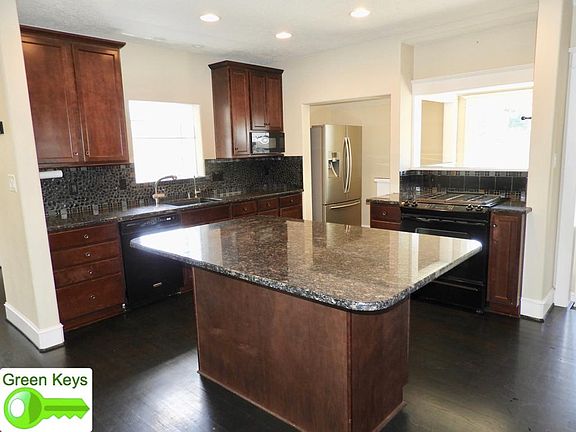Large granite-topped island in kitchen