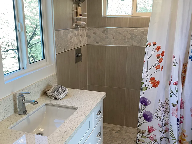 generous bathroom with toilet, sink and spacious shower