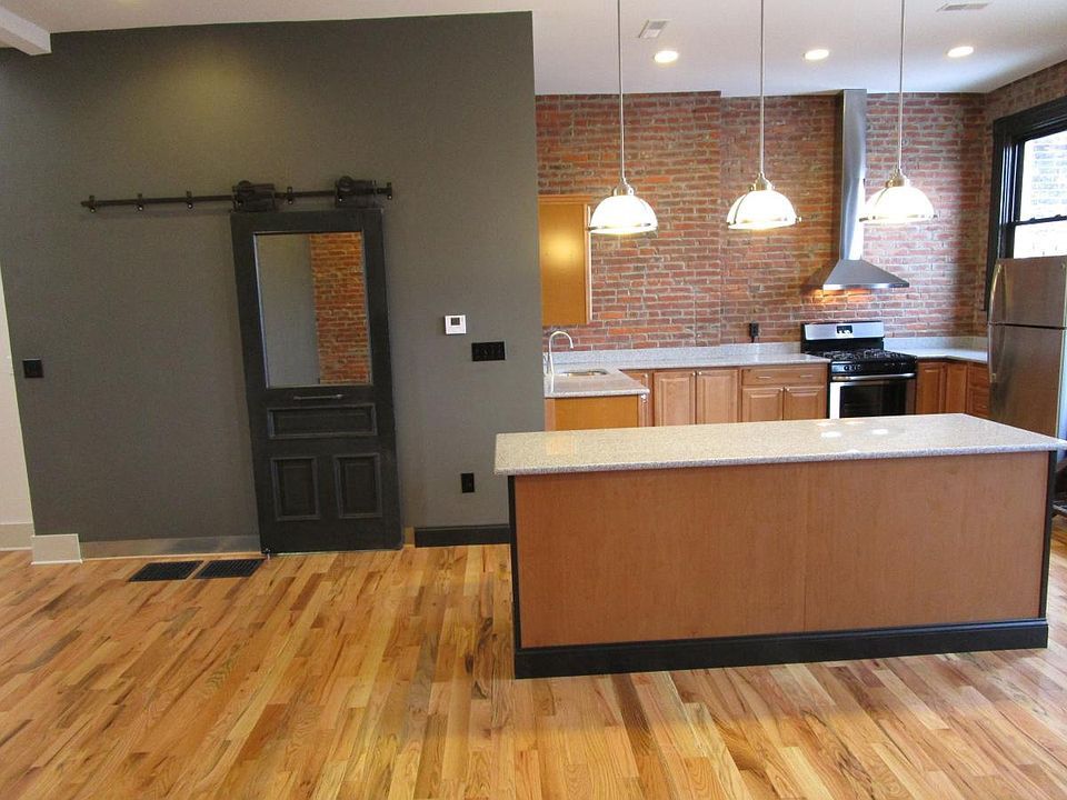 Bright Kitchen with window out to deck & more counter space. Hooded range for a clean, grease & fume free space. Laundry Room Door