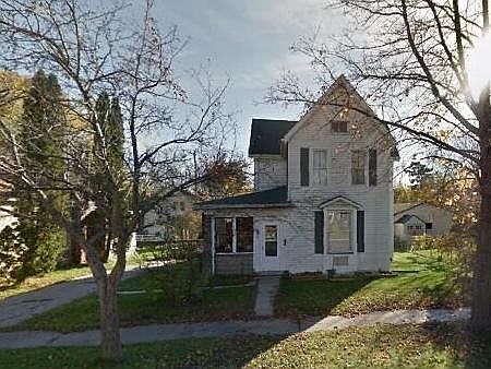 Lower unit includes enclosed porch space with windows that open and off street parking