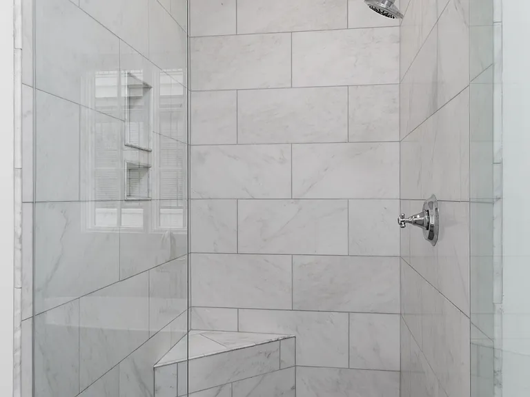 Full Bathroom connected to bedroom 1 with double vanity, shower, and large bathtub.