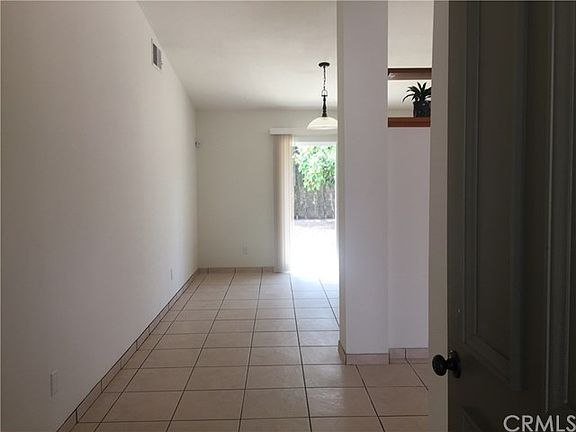 Entry into home looking toward kitchen area. Family room is on the right. Bedrooms and baths are to the left.