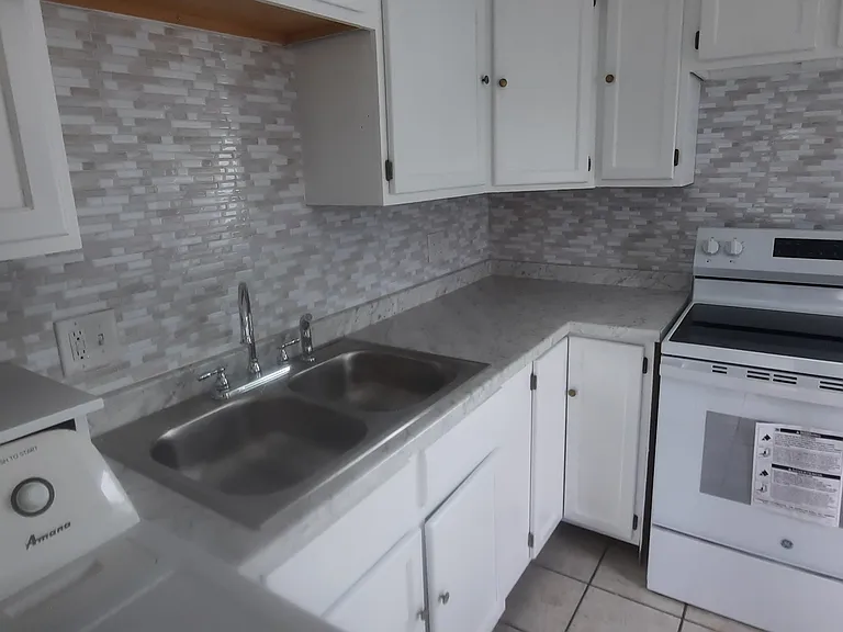Freshly updated kitchen, new countertop, backsplash, stove and fridge