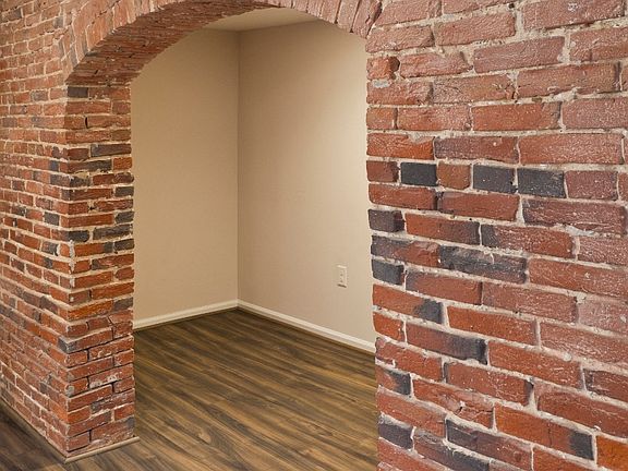 Original exposed brick and brand new plank flooring