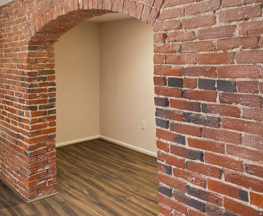 Original exposed brick and brand new plank flooring