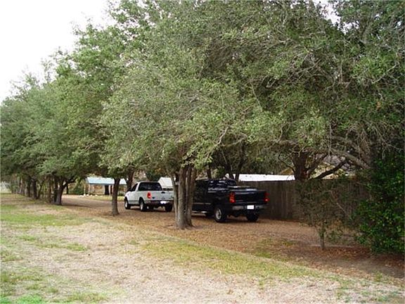  Home sits on 1 acre   surrounded by Mature Oak Trees and has additional 3.87 acres included with purchase.