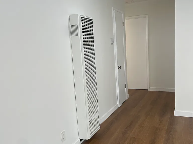 Wall heater and hallway to both bedrooms and bathroom.