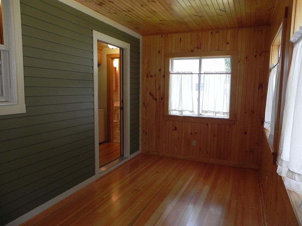 Enclosed porch with windows facing south and west.
