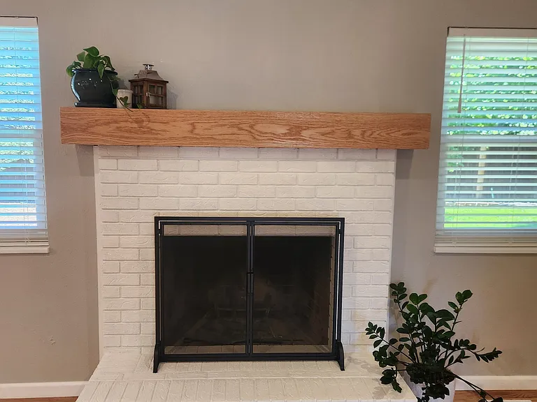 Wood burning fireplace with new mantle and screen.