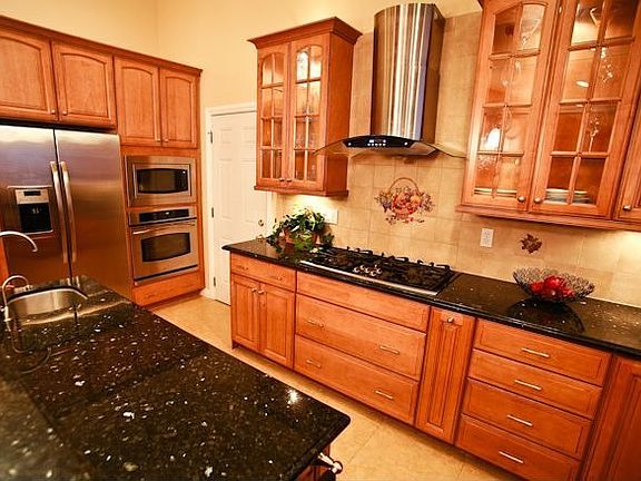 GE Profile stainless steel appliances and Kobe hood fan.