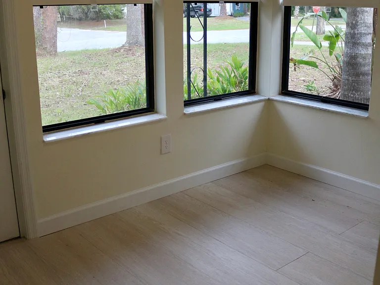 It wouldn't be Florida without a Florida room for soaking up the sunrise. Beautiful palm and lush plants surround this view.