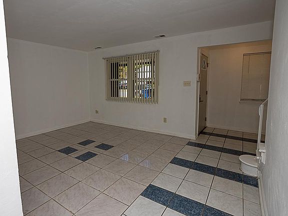 Enter into a foyer with coat closet then the front living room with beautiful ceramic tile floors -