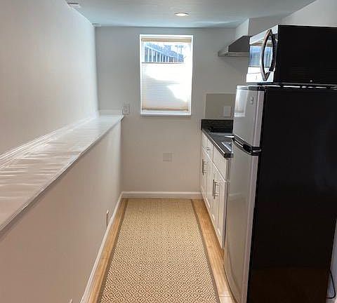 Kitchen with refrigerator, convection oven/microwave, two-burner electric stove, sink disposal
