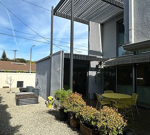 Side yard with raised bed garden.
