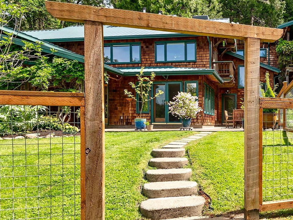 Modern hog panel fencing surrounding yard with large removable gates.
