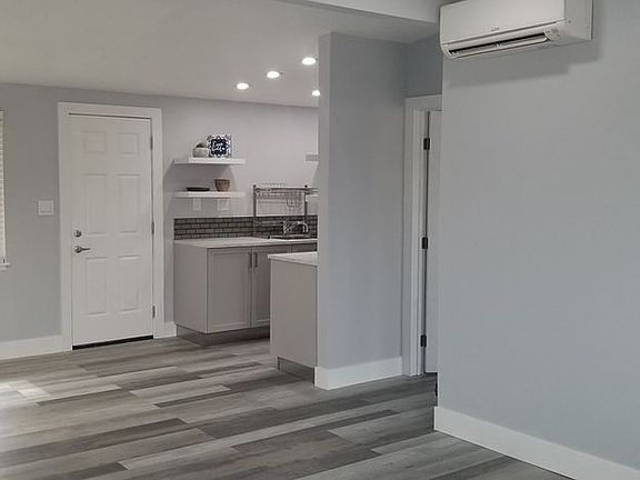 Front door looking at living room and kitchen