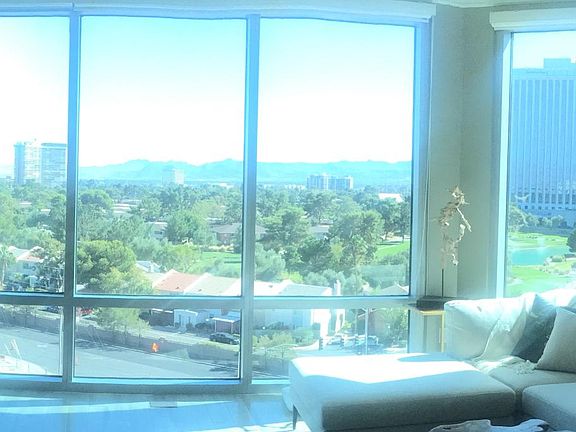 Glass panel view of Mountains, Lucious golf course and pond