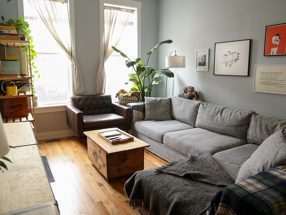 Living room area. The front door is located beside the shelf on the left.