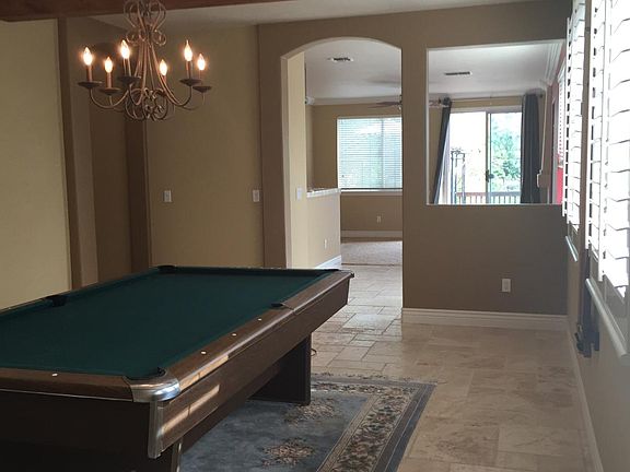 Looking through living room custom tile to kitchen and famil