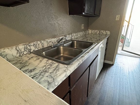 Kitchen by back door. Includes dishwasher, clothes washer and dryer hook ups.