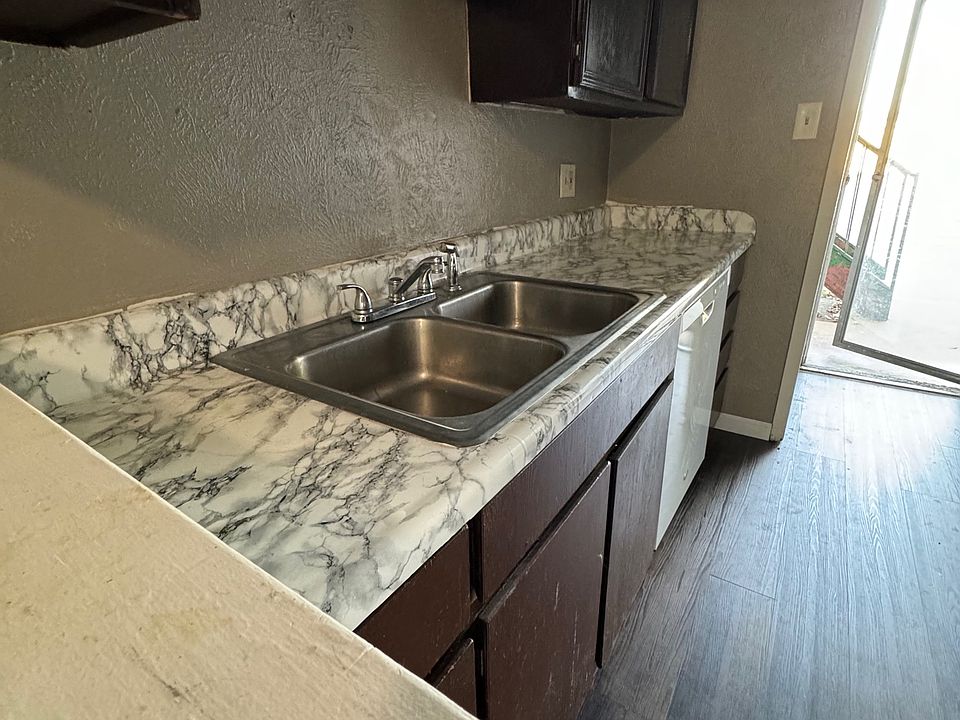 Kitchen by back door. Includes dishwasher, clothes washer and dryer hook ups.