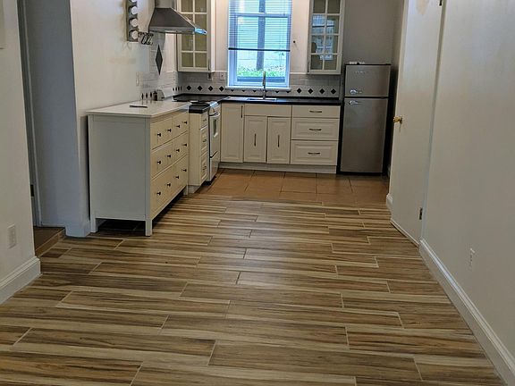 View from living area to kitchen with new stone floor