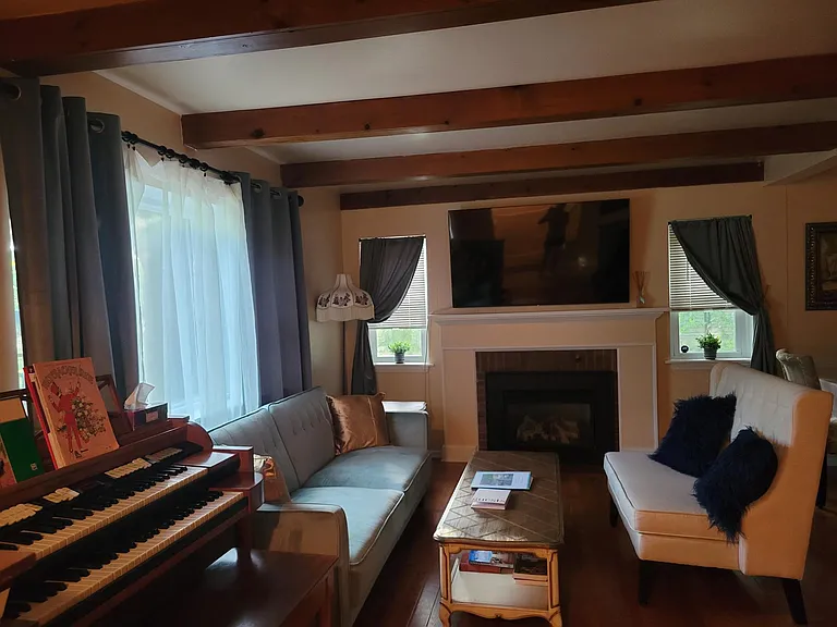 Cozy gas fireplace, 65", pullout couch and my Grandma's awesome organ!