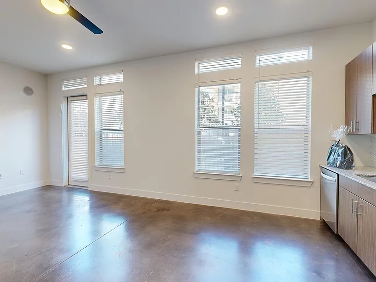 Apartment living room with polished concrete flooring.