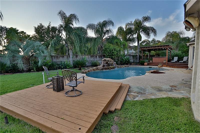 Side view of pool with waterfall and jacuzzi.