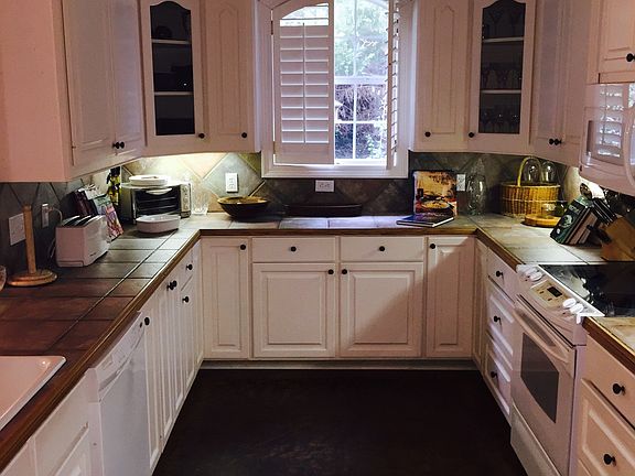 Kitchen with Ceramic tile Countertops and Scored Concrete Fl