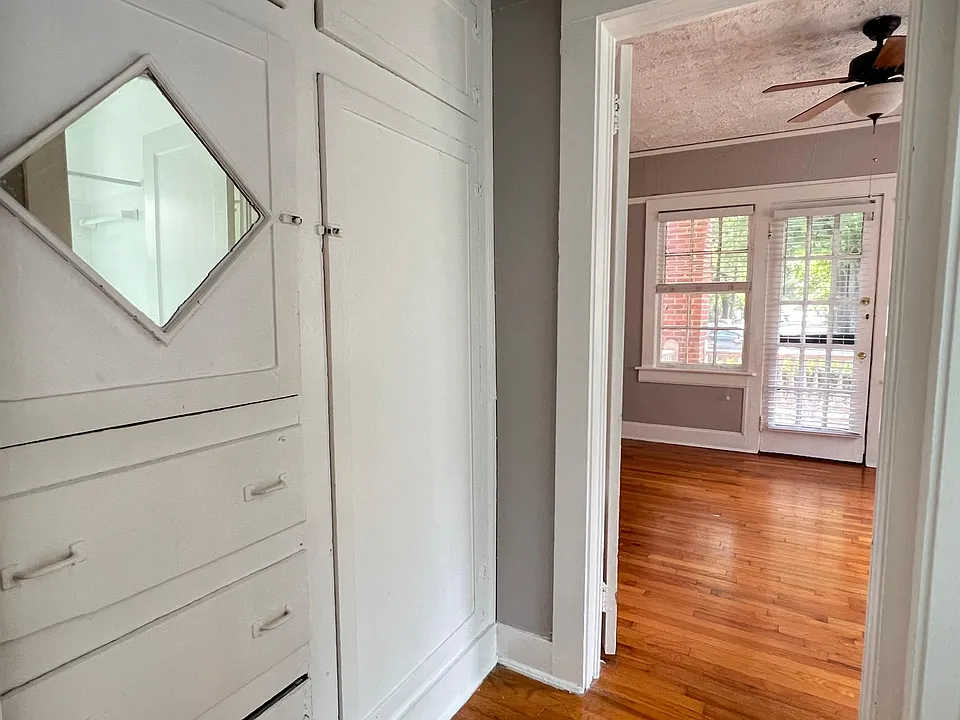 Hallway to bedroom has original built in cabinetry