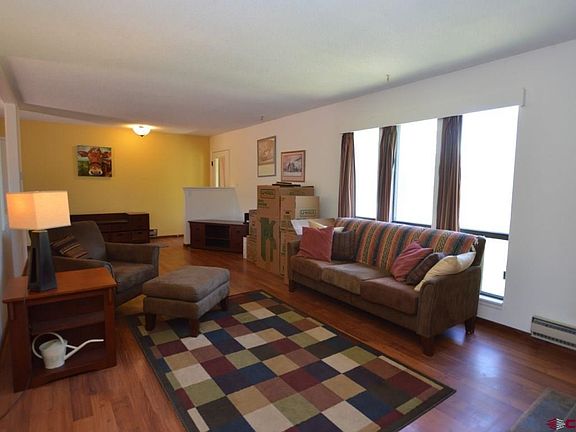 Living room with large picture window allowing natural morning light