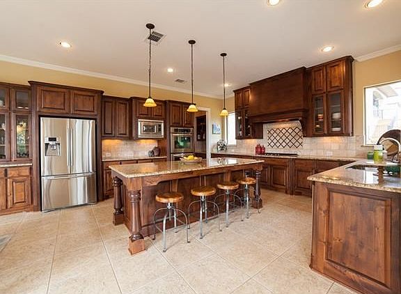 Fabulous gourmet kitchen with large center island, granite counter tops and stainless steel applianc