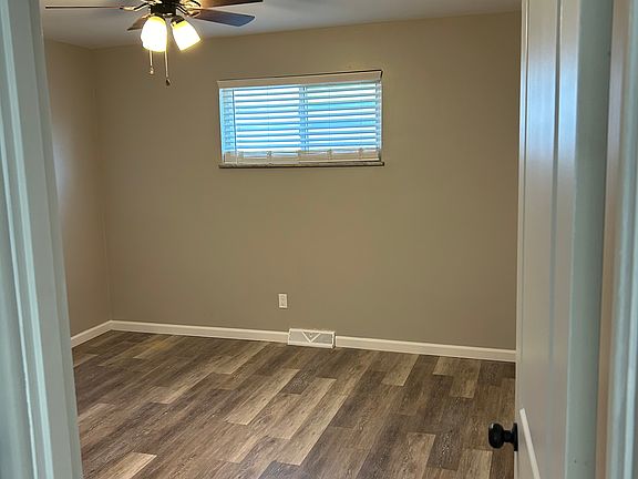 Bedroom with large closet and ceiling fan.