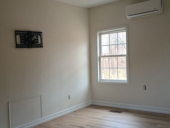 Bedroom with new flooring and paint - also has TV mount.