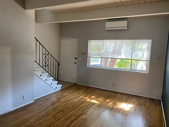 LIVING ROOM FACING FRONT DOOR, WINDOWS, AND STAIRS - PHOTO 1