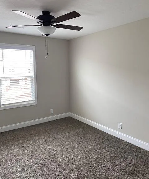 2nd bedroom with fan and closed