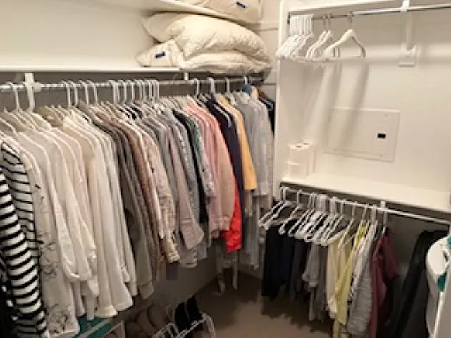 walk in closet positioned convienently between master bath and master bedroom