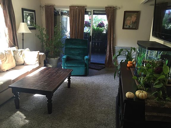Living room with private front enclosed deck with gate. Large shed on front deck also. Slider door has been upgraded with new vinyl slider since photo was taken.