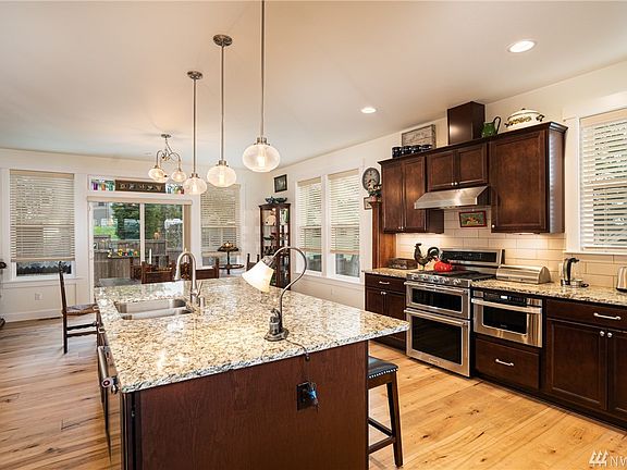 Another view of the kitchen looking toward the dining room. Spacious gourmet kitchen features granite counters, soft-close custo
